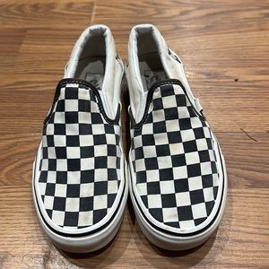 Size 6 1/2 woman’s black and white checkered Vans slip ons.